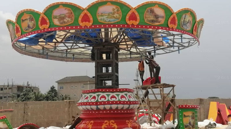 Installation of swing ride in dream world amusement park