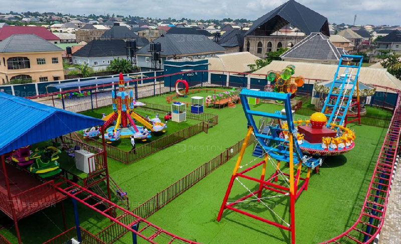 Green worm kiddie roller coaster in Nigeria